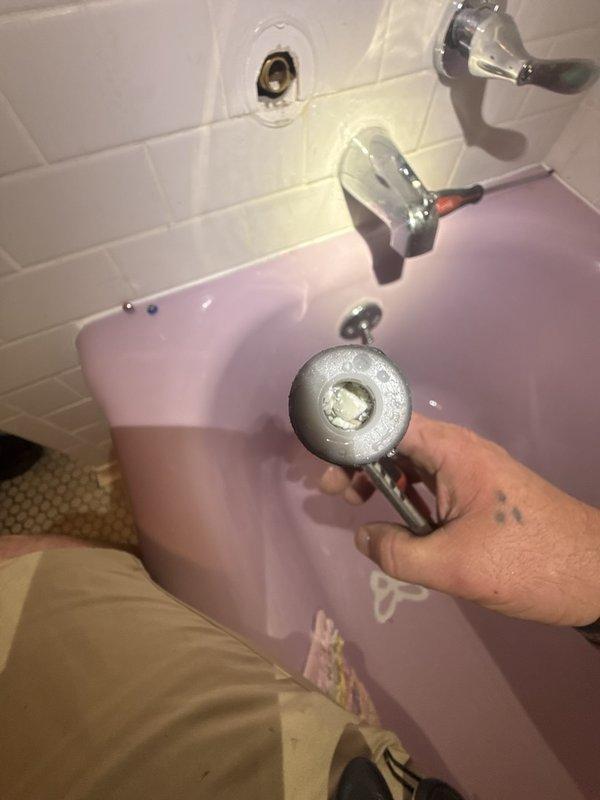 Responded to low water pressure complaint in second-floor bathroom bathtub. Inspected bathtub faucet fixture and plumbing connections, identifying restricted flow issue. Serviced chrome-plated tub spout and verified proper water pressure restoration from dual water heater system supplying the residence.