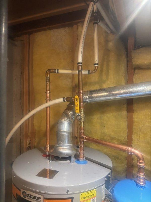 Completed installation of a 40-gallon gas-fired water heater in residential utility room. Configured copper piping connections at unit inlet and outlet, installed thermal expansion tank on cold water supply line to protect against pressure buildup from thermal expansion. Verified all connections for proper sealing, confirmed gas line connections meet code requirements, and ensured adequate clearances around unit for service access and combustion air circulation.