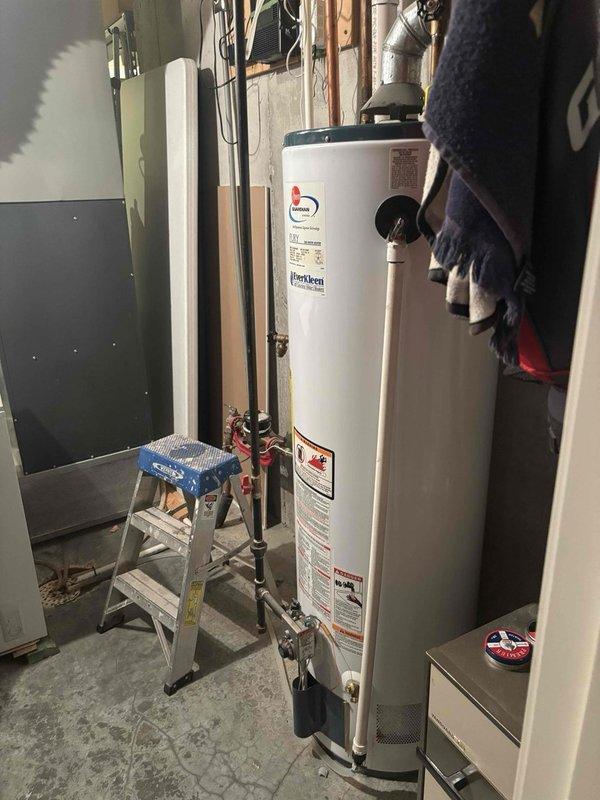 Installed a 50-gallon gas water heater in the basement utility area with proper copper piping connections and metallic exhaust venting. Coordinated with HVAC technician to install a 1/4 turn ball valve for the existing humidifier system, replacing the previous saddle valve configuration. All plumbing connections were secured, expansion tank was properly positioned, and the installation was completed to code specifications.