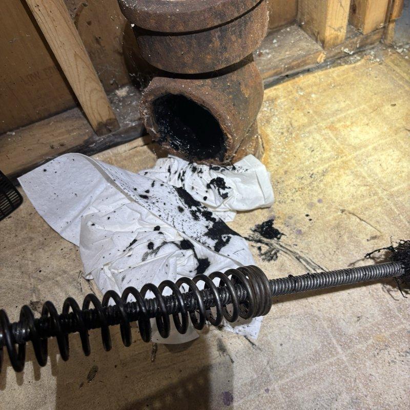 Responded to basement main drain running slow. Successfully cleared blockage in main drain line using mechanical auger snake through cleanout access point. Drain now flowing freely at normal rate. Recommended annual camera scope inspection to monitor drain condition and identify potential issues before they cause backups.