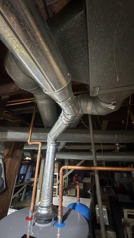 Completed installation of a 50-gallon gas-fired water heater in basement utility area. Installed thermal expansion tank on cold water supply line to protect against pressure fluctuations and comply with plumbing code requirements. Connected all copper supply piping with appropriate shut-off valves, established proper venting for gas appliance, and tested system for leaks and proper operation upon completion.