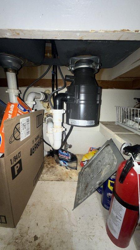 Responded to service call for locked-up garbage disposal in kitchen. Upon inspection, identified jamming issue preventing disposal operation. Accessed disposal unit from beneath sink cabinet, freed impeller mechanism, and restored full functionality. Tested unit to verify proper operation and confirmed splash guard assembly was properly seated and functioning correctly.
