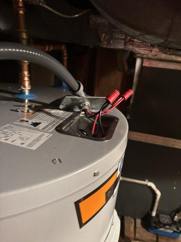 Completed estimate for replacement of 50-gallon short electric water heater located in basement crawl space. Existing 15+ year old unit is currently operational but actively leaking. Installation will require addition of thermal expansion tank, as current system does not have one installed. Unit positioned in same area as furnace with connections to existing electrical service and copper supply lines with brass fittings visible at top connections.