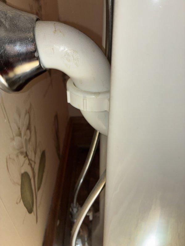 Completed comprehensive whole home plumbing inspection of residential property. Examined bathroom fixtures including cultured marble vanity sink with chrome single-handle faucet assembly and pop-up drain stopper mechanism, all components functioning properly with no visible leaks at fixture connections. Inspected water heater installation and associated piping, noting PVC to metal pipe transition connections in utility area with evidence of previous moisture staining on adjacent wall surfaces requiring monitoring for potential leak sources.