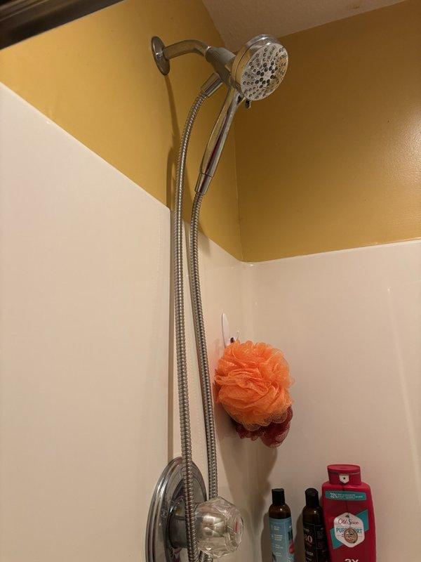 Responded to emergency service call for third-floor bathroom shower that would not shut off, requiring homeowner to turn off main water supply to stop flow. Upon arrival, inspected dual showerhead system with chrome fixtures including fixed overhead and handheld units. Diagnosed faulty shower valve cartridge preventing proper water shutoff. Replaced defective cartridge, tested operation of both showerheads, and restored full water service to home. System now functions properly with complete shutoff capability.