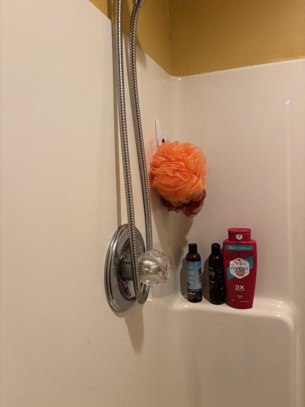 Responded to emergency service call for third-floor bathroom shower that would not shut off, requiring homeowner to turn off main water supply to stop flow. Upon arrival, inspected dual showerhead system with chrome fixtures including fixed overhead and handheld units. Diagnosed faulty shower valve cartridge preventing proper water shutoff. Replaced defective cartridge, tested operation of both showerheads, and restored full water service to home. System now functions properly with complete shutoff capability.