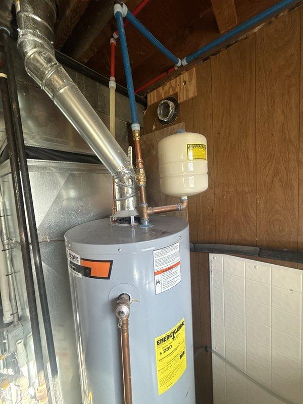 Conducted routine inspection of water heater flue pipe and venting system in basement installation. Verified proper operation of water heater unit with no deficiencies noted. Inspected galvanized metal flue duct extending through attic space, confirming secure connections and proper clearances from combustible materials. Examined water heater plumbing connections including copper supply lines, PEX distribution piping, and expansion tank installation. All components found to be functioning within normal parameters with no symptoms or issues present. Completed new account setup and established primary contact information for future service needs.