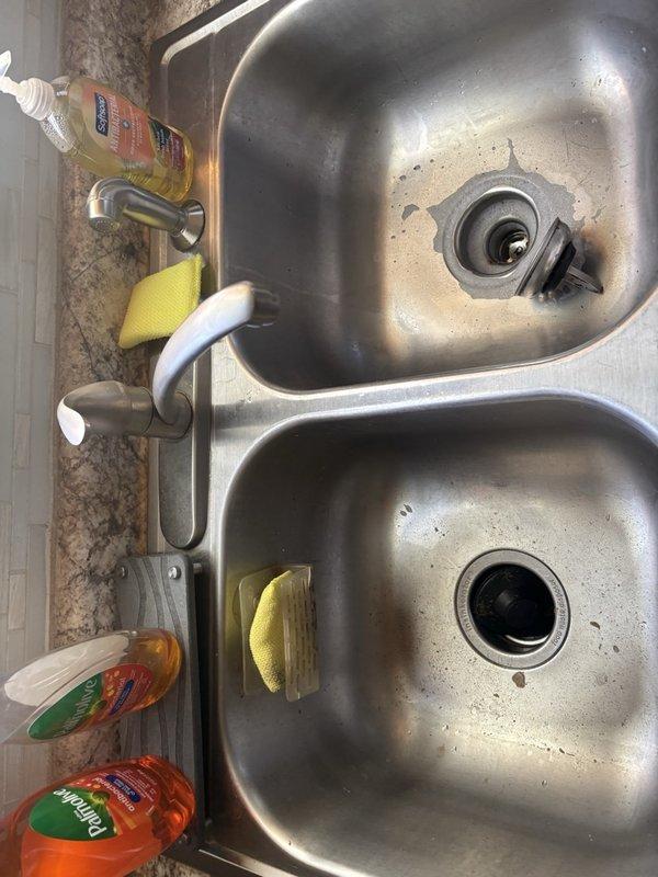 Responded to service call for kitchen sink not draining on main floor. Upon arrival, inspected stainless steel double-basin sink with dual garbage disposal units. Assessed drainage issue in affected basin and cleared blockage from disposal system. Tested both basins for proper water flow and verified garbage disposal units were functioning correctly. Confirmed complete drainage restoration and left work area clean and operational.