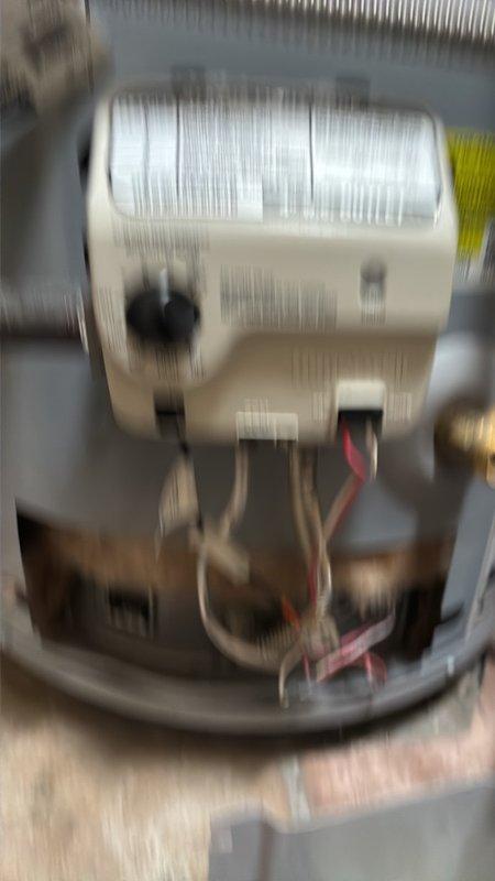 Responded to service call for gas water heater with non-functioning pilot light in utility room off garage. Upon arrival, conducted visual inspection and confirmed no water leakage at base of unit, ruling out tank failure. Accessed burner assembly and pilot light components to diagnose ignition system failure. Cleaned pilot assembly, inspected thermocouple for proper positioning and functionality, and tested gas supply to pilot orifice. Relit pilot light following manufacturer safety procedures and verified flame stability and proper blue coloration. Tested main burner ignition cycle and confirmed water heater returned to normal operation with adequate heat production.