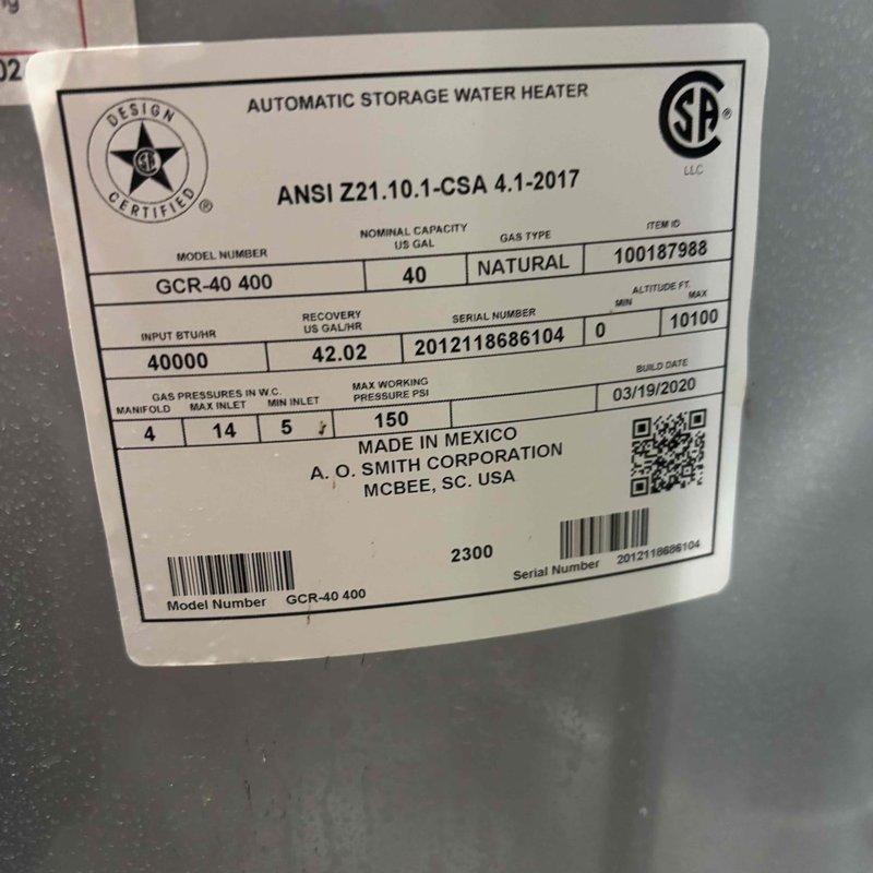 Completed comprehensive plumbing inspection of residential water heating system. Inspected A.O. Smith 40-gallon natural gas water heater (Model GCR-40 400, manufactured March 2020) including verification of proper venting through galvanized flue pipe with elbow configuration, assessment of copper supply line connections showing age-appropriate patina, and examination of gas manifold pressures per manufacturer specifications. All components photographed and documented for record, with system found operational at time of inspection.