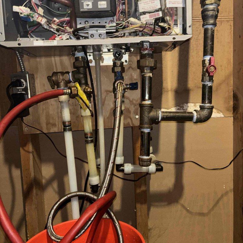 Performed scheduled preventive maintenance on wall-mounted tankless water heater system. Completed thorough flush procedure to remove mineral buildup and sediment accumulation from heat exchanger. Connected flush cart with circulation hoses to service valves, ran descaling solution through unit per manufacturer specifications, then flushed with clean water to restore optimal performance and efficiency.