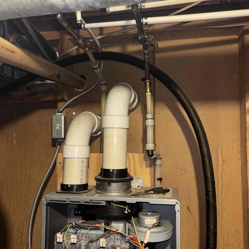 Performed scheduled preventive maintenance on wall-mounted tankless water heater system. Completed thorough flush procedure to remove mineral buildup and sediment accumulation from heat exchanger. Connected flush cart with circulation hoses to service valves, ran descaling solution through unit per manufacturer specifications, then flushed with clean water to restore optimal performance and efficiency.