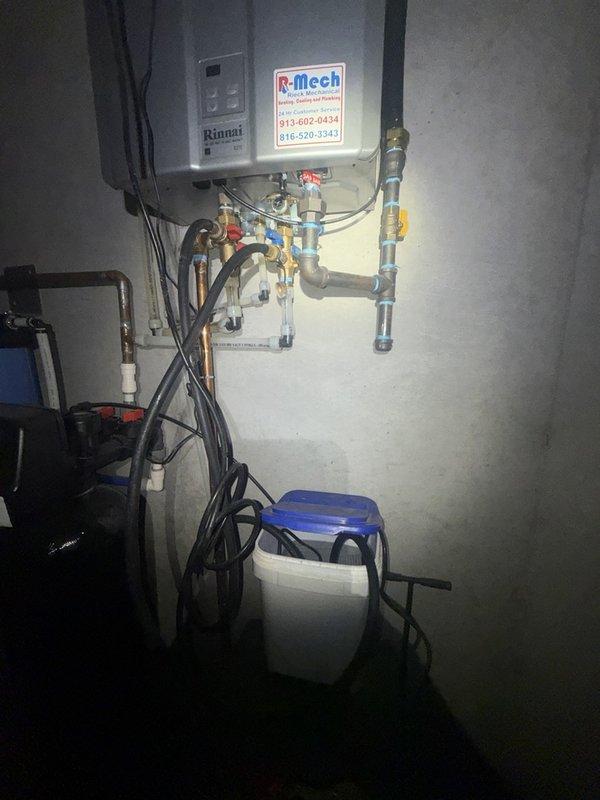 Performed preventative maintenance flush on Rinnai tankless water heater unit to remove mineral buildup and sediment accumulation from the heat exchanger. Isolated unit using service valves, circulated descaling solution through the system, and verified proper flow restoration upon completion. Additionally inspected toilet supply line connections on first and upper floors as part of service assessment for future valve replacement recommendations.