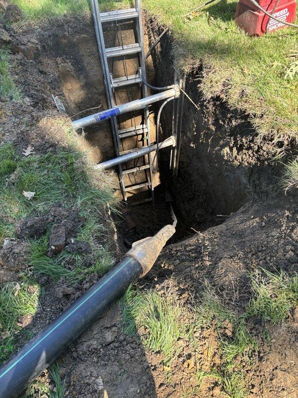 Completed sewer line replacement using pipe bursting method to install new piping under driveway with minimal landscape disturbance. Excavated trenches on both sides of driveway at previous repair location and extended excavation near main line to remove deteriorated clay tile piping. Utilized hydraulic expansion equipment with cable and winch system to pull new same-size pipe through existing line, bursting original pipe during installation. Heat-welded replacement pipe sections above ground to ensure strong, durable connections throughout the run. Successfully removed compromised clay tile sections and established new continuous sewer line from property connection to main, restoring proper wastewater conveyance.