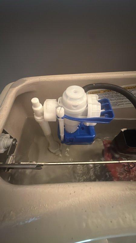 Responded to service call for two malfunctioning toilets in main bathrooms. First toilet exhibited continuous running condition due to faulty fill valve assembly. Inspected tank components and identified worn flapper seal and improperly adjusted float mechanism causing constant water flow. Second toilet produced loud noise during and after flushing, traced to defective fill valve creating water hammer effect. Removed tank lids on both units for diagnostic inspection. Documented existing flush valve assemblies, float ball valve systems, and internal tank mechanisms via photographs. Addressed both issues by adjusting float heights, checking flush valve seals, and ensuring proper water pressure regulation to eliminate running water and noise concerns.