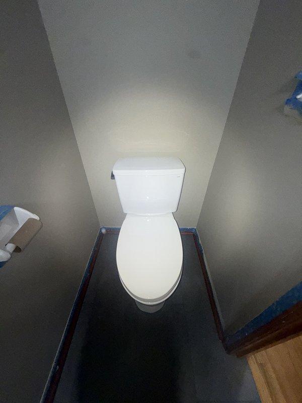 Completed installation of customer-supplied toilet in residential bathroom. Removed existing fixture, installed new wax ring to create proper seal between toilet and waste flange, and secured toilet to floor. Verified proper operation, checked for leaks, and confirmed water supply connection functioning correctly. Installation includes accessibility features with wall-mounted grab bars on both sides of fixture for safety compliance.