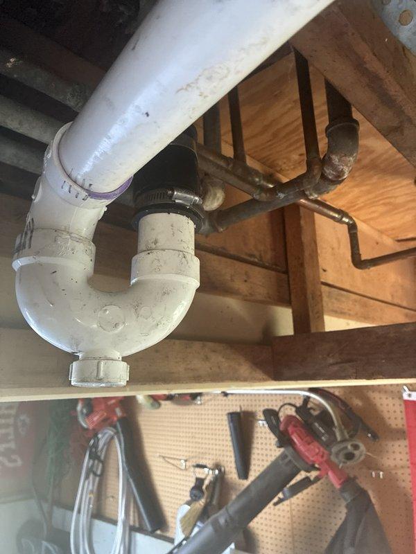 Completed full repipe of existing plumbing system, removing severely corroded metal piping and fittings that had deteriorated beyond serviceable condition. Installed new PVC drainage system including P-trap configuration under sink area, ensuring proper venting and code-compliant connections with secure fittings and clamps.