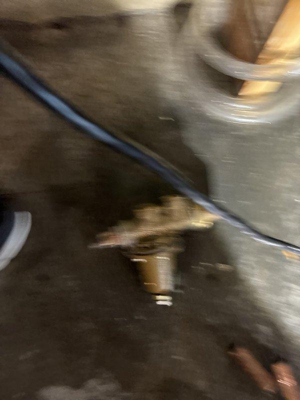 Responded to low water pressure complaint occurring when multiple fixtures were operated simultaneously. Diagnosed and replaced deteriorated pressure regulator valve showing signs of internal component failure and mineral buildup. Removed old brass valve assembly exhibiting corrosion and sediment accumulation that was restricting water flow throughout the system. Installed new pressure regulator to restore adequate water pressure and ensure consistent flow when multiple water sources are in use concurrently. Recommended water softener maintenance to prevent future mineral deposit issues affecting plumbing components.
