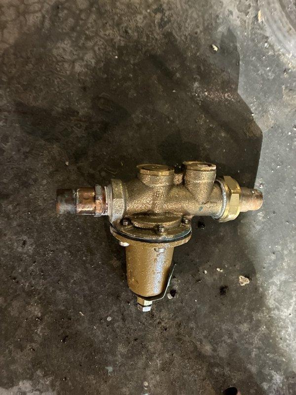 Responded to low water pressure complaint occurring when multiple fixtures were operated simultaneously. Diagnosed and replaced deteriorated pressure regulator valve showing signs of internal component failure and mineral buildup. Removed old brass valve assembly exhibiting corrosion and sediment accumulation that was restricting water flow throughout the system. Installed new pressure regulator to restore adequate water pressure and ensure consistent flow when multiple water sources are in use concurrently. Recommended water softener maintenance to prevent future mineral deposit issues affecting plumbing components.