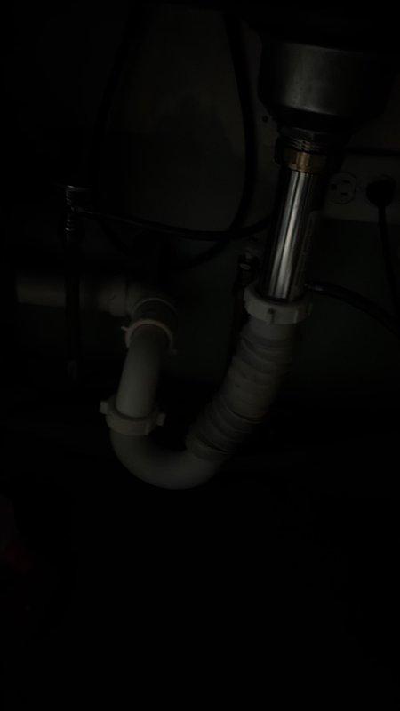 Installed under-sink water treatment system in kitchen area. Connected treatment unit to existing plumbing configuration, integrating with P-trap assembly and disposal unit drainage system. Verified proper flow and secure mounting of all components.