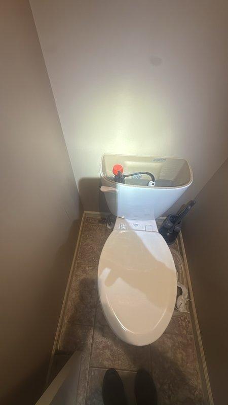 Responded to ongoing toilet tank noise issue occurring every 5–10 seconds following previous float replacement. Upon inspection of master bathroom toilet tank, identified faulty flapper valve as root cause of intermittent refilling cycle. The existing red circular flapper showed signs of improper seating and wear, preventing complete seal at flush valve opening. Replaced defective flapper assembly with new component and adjusted chain length to ensure proper drop and seal. Tested flush mechanism through multiple cycles to verify elimination of phantom flushing. Confirmed water level settings and float operation within manufacturer specifications. Unit now operates silently without intermittent refilling cycles.