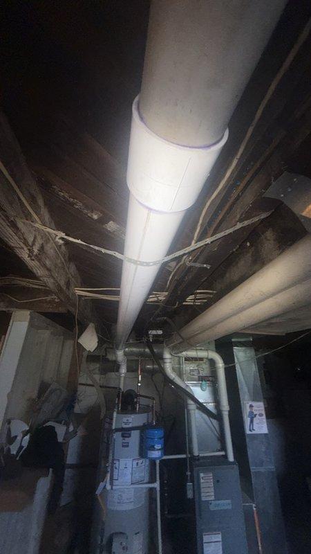 Completed installation of a 50-gallon power vent water heater with thermal expansion tank in a confined basement utility space. The compact short-style unit was selected specifically to accommodate the tight clearances in the installation area. Connected all copper water supply lines, installed new PVC power vent piping routed vertically through the ceiling structure, and integrated the thermal expansion tank to protect against pressure buildup in the closed plumbing system. Established all electrical connections to the power vent motor and verified proper operation. All plumbing connections were secured with appropriate fittings, and the vent termination was completed per manufacturer specifications and local code requirements. System was tested for proper heating function, venting performance, and leak-free operation before final inspection.