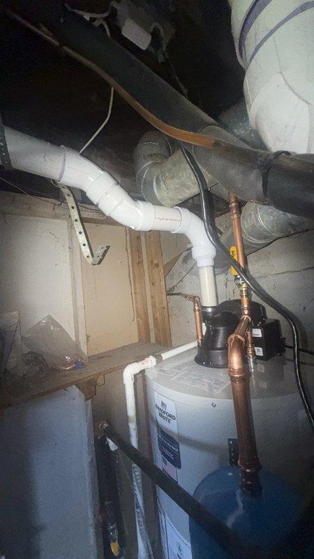 Completed installation of a 50-gallon power vent water heater with thermal expansion tank in a confined basement utility space. The compact short-style unit was selected specifically to accommodate the tight clearances in the installation area. Connected all copper water supply lines, installed new PVC power vent piping routed vertically through the ceiling structure, and integrated the thermal expansion tank to protect against pressure buildup in the closed plumbing system. Established all electrical connections to the power vent motor and verified proper operation. All plumbing connections were secured with appropriate fittings, and the vent termination was completed per manufacturer specifications and local code requirements. System was tested for proper heating function, venting performance, and leak-free operation before final inspection.