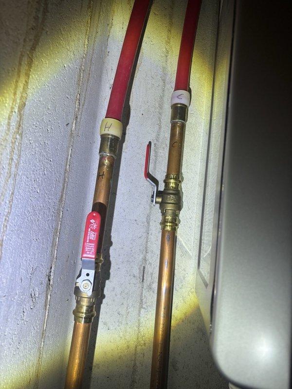 Completed plumbing maintenance visit including tankless water heater flush as part of routine preventative maintenance program. Inspected water supply lines with brass fittings and isolation valves, verified proper insulation on copper piping, and examined internal components including circulation pump, electrical connections, and drainage system. All components found in proper working condition with normal wear patterns consistent with regular operation.