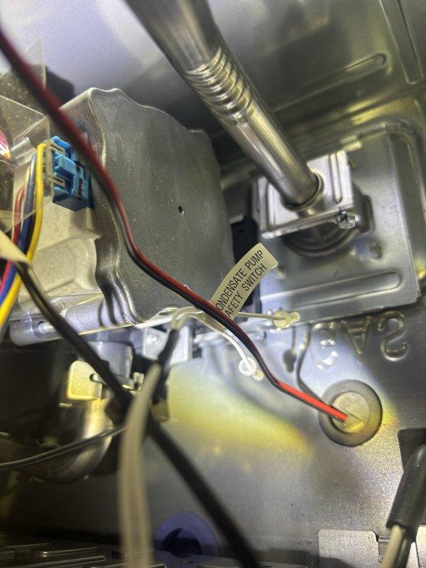 Completed plumbing maintenance visit including tankless water heater flush as part of routine preventative maintenance program. Inspected water supply lines with brass fittings and isolation valves, verified proper insulation on copper piping, and examined internal components including circulation pump, electrical connections, and drainage system. All components found in proper working condition with normal wear patterns consistent with regular operation.