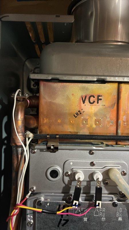 Responded to intermittent E10/E12 error codes on a wall-mounted tankless water heater. Removed the front cover and inspected the heat exchanger, flue and vent connections, ignition and flame rod terminals, wiring harness, and control board. Found heat discoloration on the copper heat exchanger and no visible frost, rust, or physical damage. Verified wiring and terminal connections and confirmed the vent and combustion air pathways were intact.