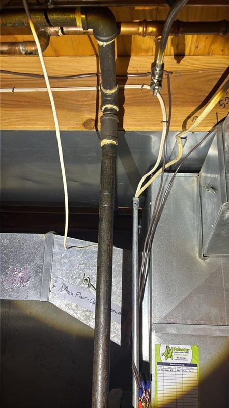 Performed an on-site estimate for installing a new gas line from the basement to the kitchen. Inspected the basement joist space and existing black iron gas piping, noting adjacent copper supply lines, PVC drain piping, ductwork, and electrical cabling that will affect pipe routing and joist penetrations. Documented existing conditions with photos and determined the routing path for the proposed run.