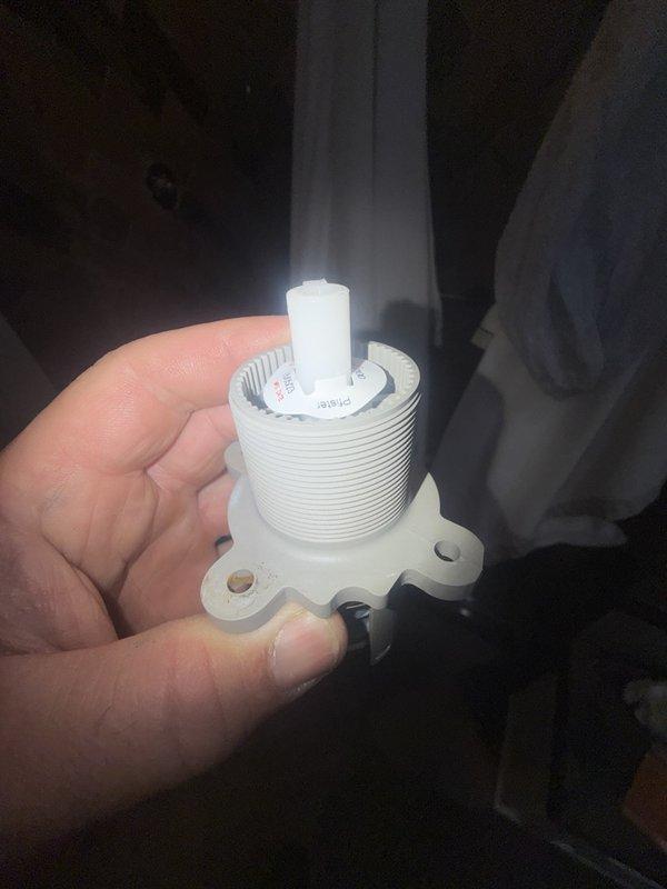 Diagnosed a leak occurring during shower operation at the valve and removed the failing Pfister cartridge, which showed surface wear and discoloration around the flange. Installed a replacement cartridge and reassembled the matte black trim plate and lever handle, then tested the valve through full operation to confirm the leak was resolved.
