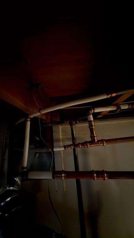 Replaced the main water shutoff valve at the water main and re-piped a leaking fitting on the water heater supply line. Installed new copper piping and pressed fittings, restored water service, and pressure-tested the connections to confirm leak-free operation.