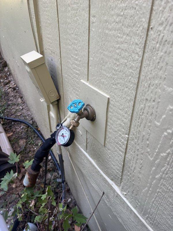 Performed a comprehensive plumbing inspection of the water supply system, including the exterior hose bib with attached pressure gauge and the brass backflow preventer assembly with associated copper supply piping and valves, noting no signs of freezing or heavy corrosion. Flushed the tankless water heater to remove mineral and sediment buildup and restore efficient operation.