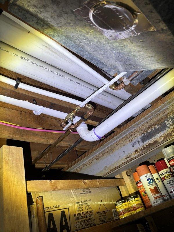 Performed a scheduled plumbing maintenance inspection of the water treatment system, including the water softener with its digital control head, and the associated copper and PEX supply lines with brass fittings. Inspected PVC drain piping, soldered copper joints, and overhead plumbing runs for leaks, corrosion, and fitting integrity, with no active leaks noted; system left in operational condition.