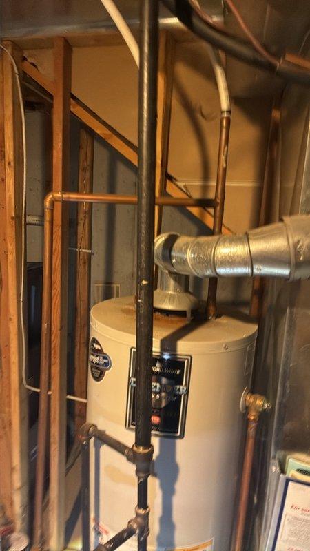 Assessed a non-operational 20-year-old gas tanked water heater in the basement and confirmed it requires full replacement. Inspected the flexible vent connector, supply piping, and water connections, and documented the existing unit and its static water pressure, which reads slightly above 100 psi, so a pressure-reducing valve and expansion tank should be evaluated at installation. Prepared a 50-gallon gas water heater replacement estimate, an upgrade from the 40-gallon capacity requested.