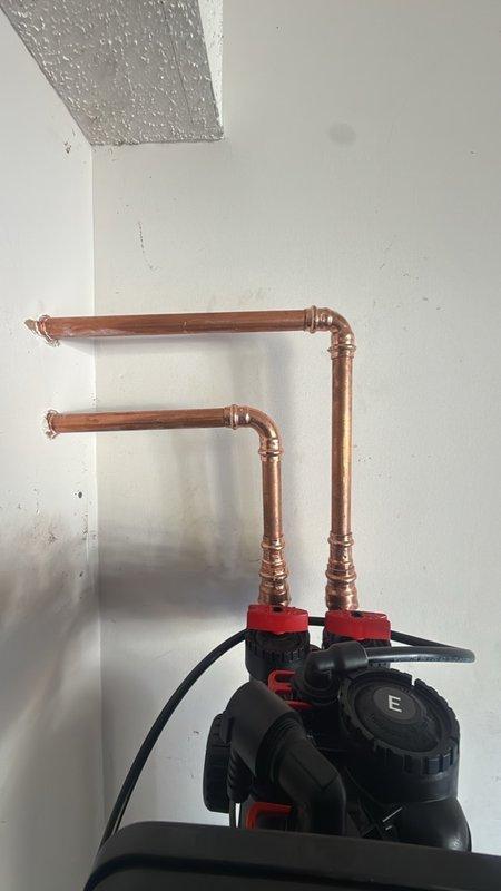 Installed a 50-gallon electric tank water heater with a thermal expansion tank to accommodate pressure fluctuations in the closed plumbing system. Also installed a Matrix MX water softener with a fiberglass resin tank, brine tank, and digital control head, connected to the supply piping with copper lines, pressed fittings, and brass connections, with insulated runs. All connections are clean and leak-free.