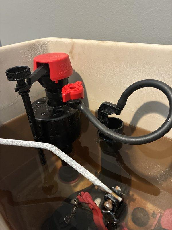 Diagnosed a continuously running toilet and found worn internal tank components, including a deteriorated flapper and fill valve, with heavy mineral staining and sediment in the tank. Replaced the fill valve and both flappers, adjusted the float and refill tube to set the proper water level, and verified the overflow tube was correctly positioned. Tested multiple flush cycles to confirm the toilet fills, shuts off completely, and holds water without leaking.