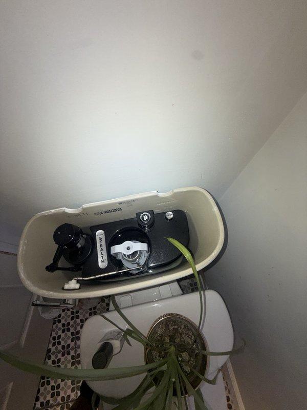 Inspected the toilet tank assembly, including the dual-flush mechanism, flapper valve, fill valve, and float, and confirmed all components were clean and free of cracking or corrosion. Evaluated the accessible drain, waste, and vent piping in the lower-level joist space, verifying that the PVC stack, elbow fittings, and horizontal drain runs were properly supported and secured with no visible leaks or defects.