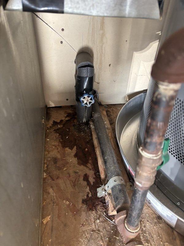Diagnosed low water pressure at the water heater and found the temperature and pressure (T&P) relief valve and adjacent supply fittings heavily corroded, restricting flow. Replaced the corroded T&P valve and associated components, restored full water flow, and verified proper pressure and operation. Noted moisture staining and corrosion on the closet floor and surrounding piping, indicating prior leakage that should be monitored.