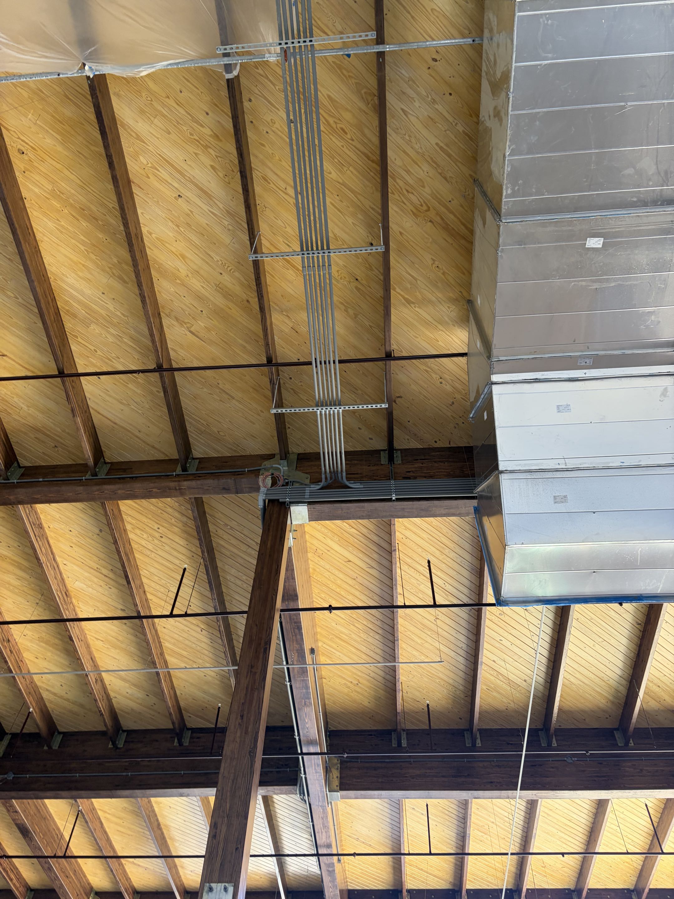 Inside the new 25k Waterpark addition. Above ceiling raceways/boxes. Pulling wire. Almost ready for fixtures!! 