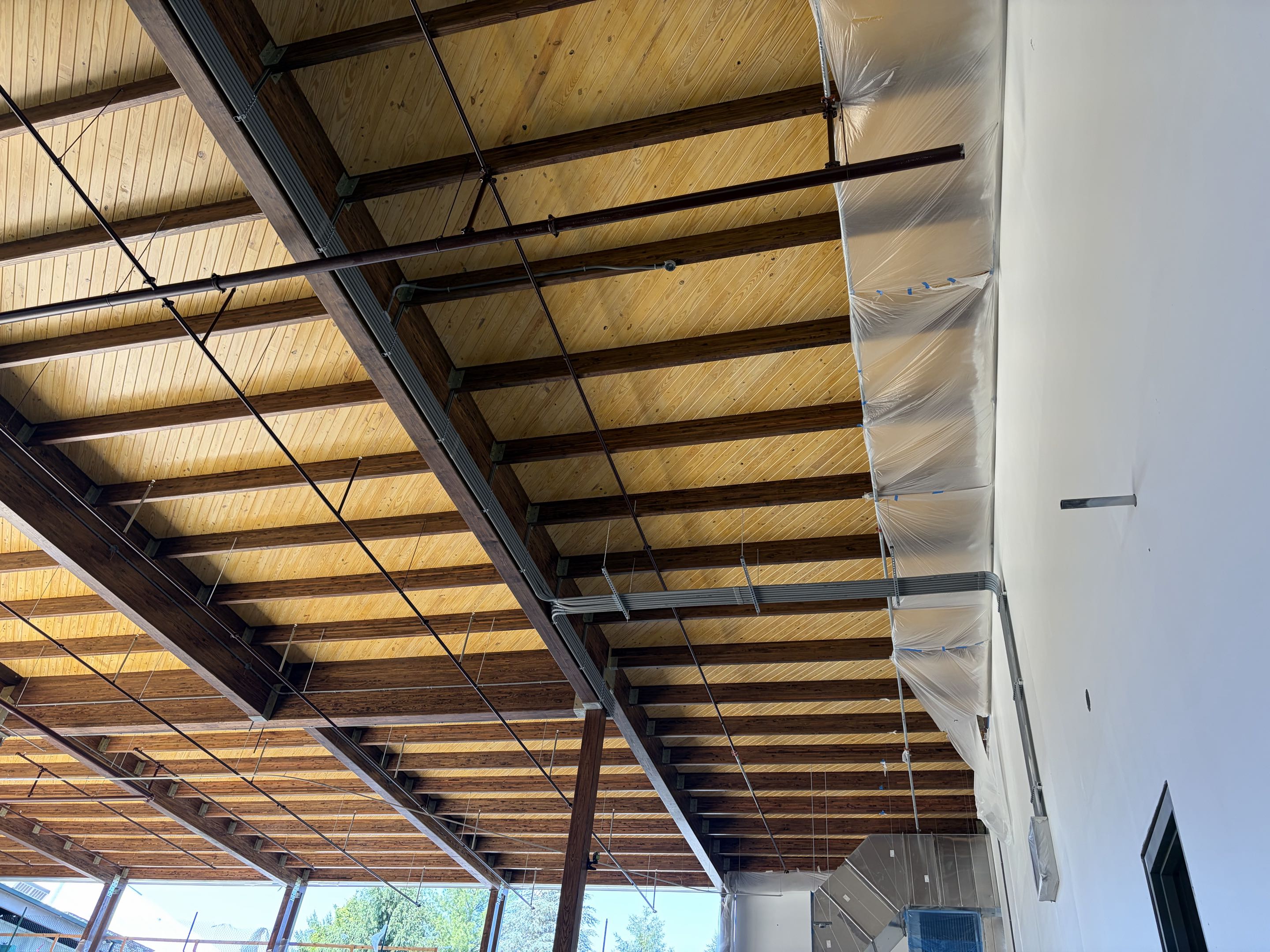 Inside the new 25k Waterpark addition. Above ceiling raceways/boxes. Pulling wire. Almost ready for fixtures!! 