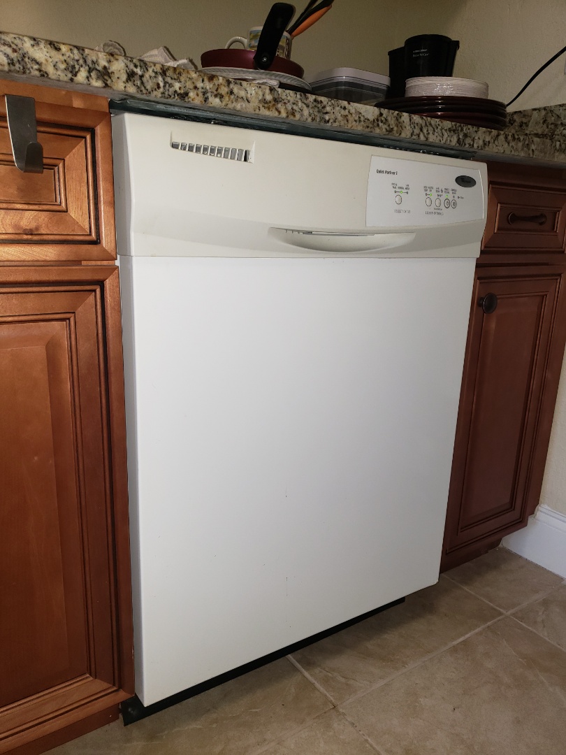 THE TECHNICIAN IS REPAIRING A WHIRLPOOL DISHWASHER. 