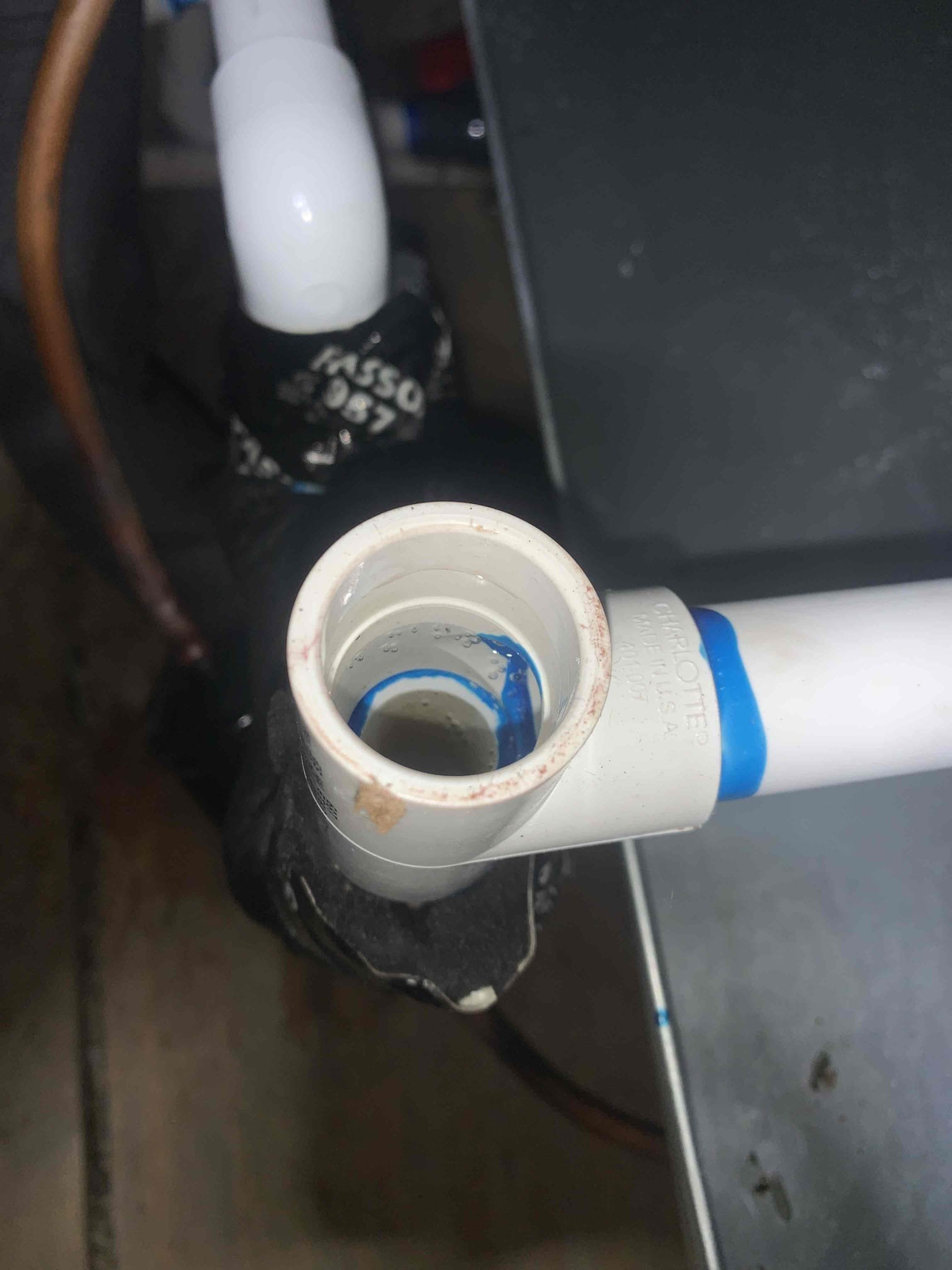 Arrived on site, and found drain line not draining properly. Blew out drain line with nitrogen and line would drain initially. However, I would receive back pressure shorty there after stopping the line from draining. Adjusted pitch of drain line to ensure that was not the issue, and had no different results. Upon tracing the drain line, I found water leaking out of the cast iron vent pipe that the drain line was tied into. Advised homeowner that unit may not work properly until this issue is addressed and that a plumber would need to address this issue. I advised the homeowner that we could run another drain line draining outside into an irrigation box, however I recommended addressing the larger issue with the vent pipe. Unit running upon departure, and drain line intermittently draining.