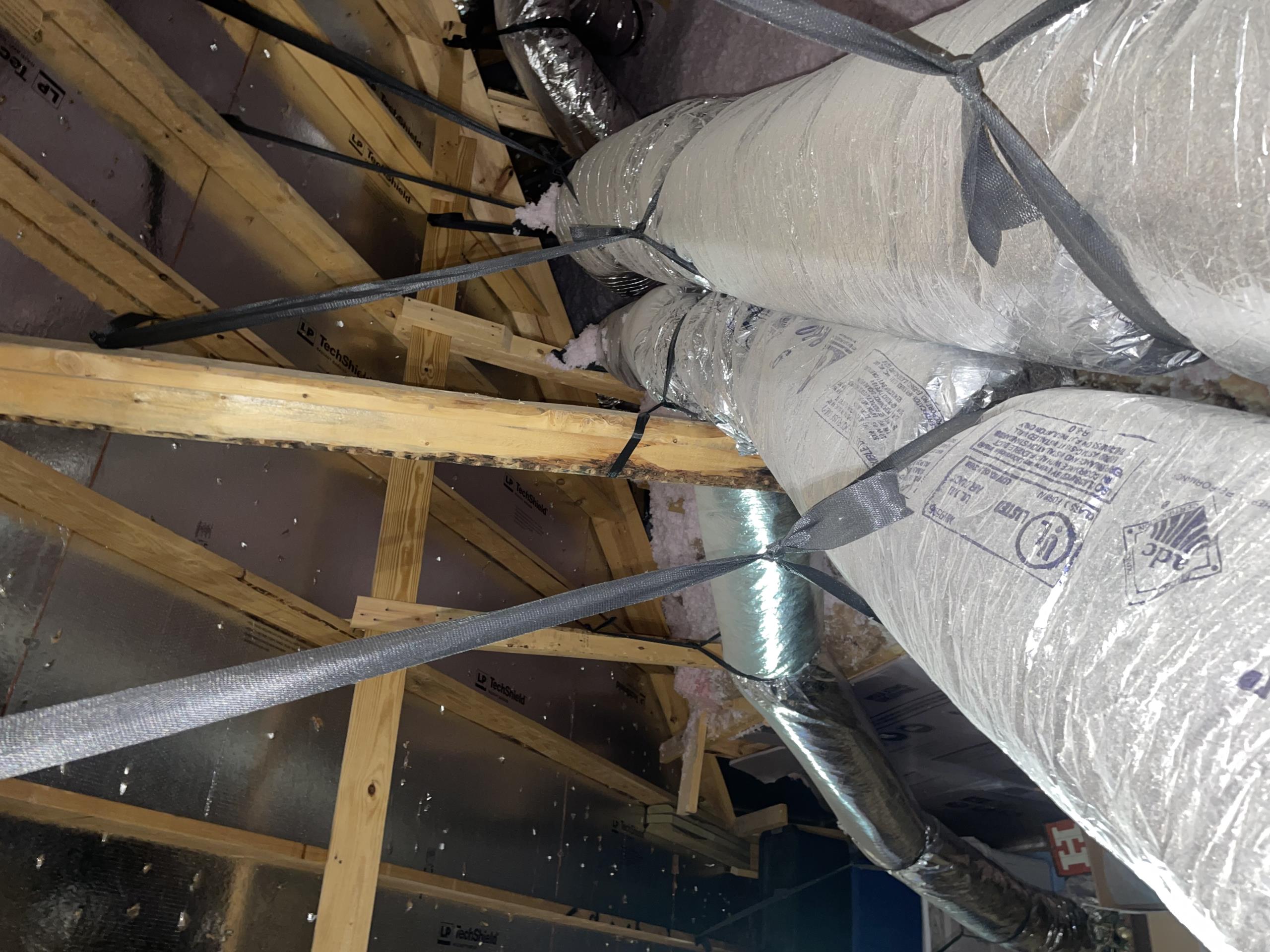 I arrived at our clients home due to air balance concerns. Mrs Perez showed me the rooms that she had concerns over. The downstairs bedrooms were not getting enough airflow while the upstairs bathroom and other vents were getting too much airflow. 
I proceeded into the upper attic area of the home and first verified that the ductwork had manual dampers which would allow for adjustments to be made. All runs do have dampers. 
I then noticed the existing bypass damper to have several tight bends which would actually restrict the airflow. 
I further confirmed that the existing 5 ton unit is undersized for the 2800sq ft home. 
I presented all of my findings to our client and we discussed adding an additional supply run and vent that would not be attached to either zones. This would allow for airflow over the loft and living room space and simultaneously alleviating the airflow for the upstairs zone. 
With this new supply run we could also do a full system airflow adjustment and restrict oth