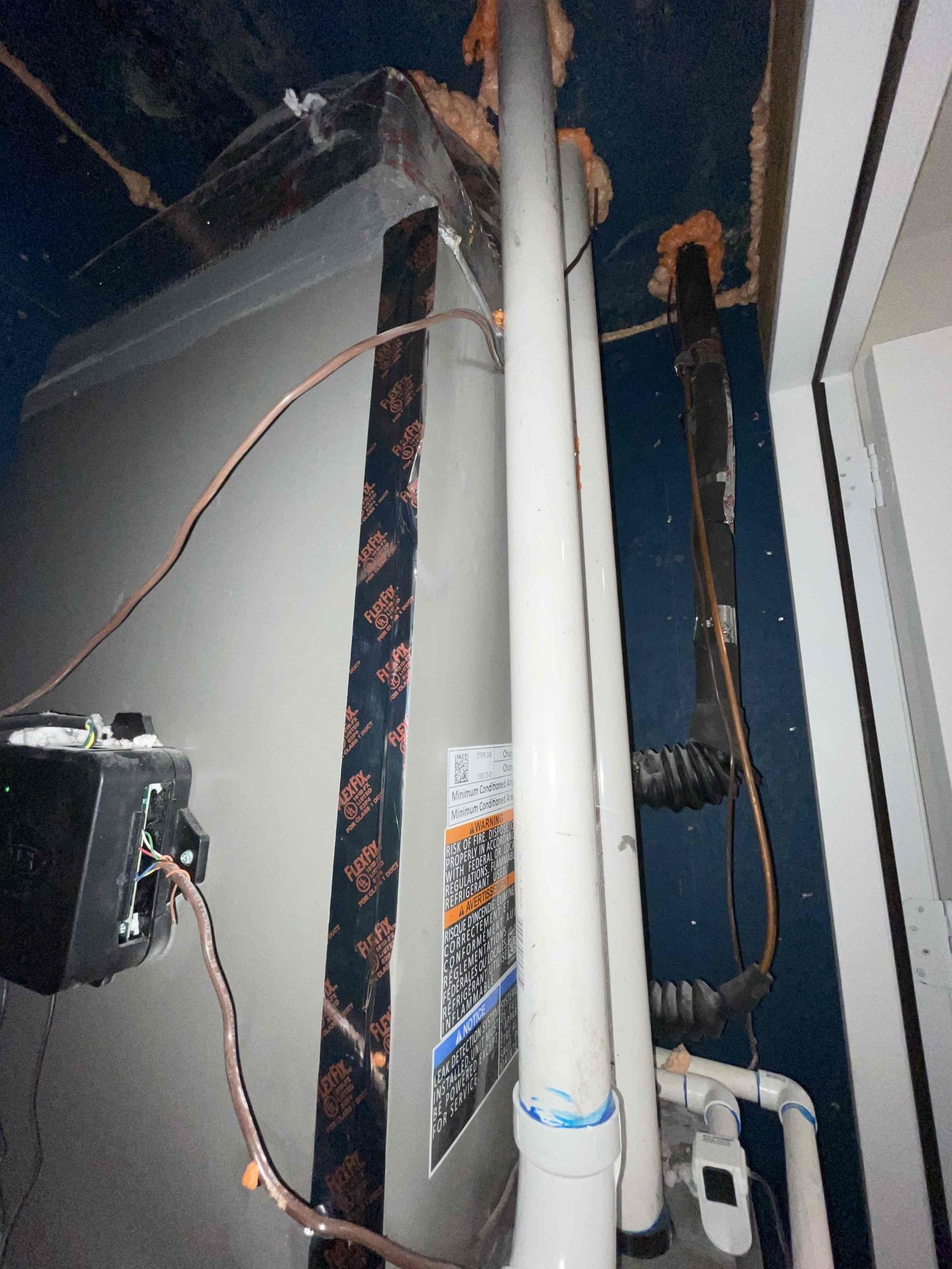 I returned to our clients home to evaluate the duct work for the newly installed 2.5 ton unit it. Previously the unit only had a single Return duct in the all way and te bedroom returns vents were still connected to the large main up-flow 5 ton unit. They made changes to the orientation no the bedroom returns and connected them properly to the correct system. This allows for proper airflow and better comfort in the master bedroom and the other bedrooms. 
The large 5 ton up-flow unit was moved also to allow for proper clearance for the air filter. The air filter was damaged and the prospective homeowner elected to leave the filter in place.
The cabinet door for the cased coil was also secured with set screws and some tape.
The larger unit does also have 2 “jump returns” in the hallway where the return vents for the “wine room” and “formal dining room” are connected to the same vent space in the ceiling. I informed the prospective buyer that this is considered correct but it again presen I returned to our clients home to evaluate the duct work for the newly installed 2.5 ton unit it. Previously the unit only had a single Return duct in the all way and te bedroom returns vents were still connected to the large main up-flow 5 ton unit. They made changes to the orientation no the bedroom returns and connected them properly to the correct system. This allows for proper airflow and better comfort in the master bedroom and the other bedrooms. 
The large 5 ton up-flow unit was moved also to allow for proper clearance for the air filter. The air filter was damaged and the prospective homeowner elected to leave the filter in place.
The cabinet door for the cased coil was also secured with set screws and some tape.
The larger unit does also have 2 “jump returns” in the hallway where the return vents for the “wine room” and “formal dining room” are connected to the same vent space in the ceiling. I informed the prospective buyer that this is considered correct but it again presen