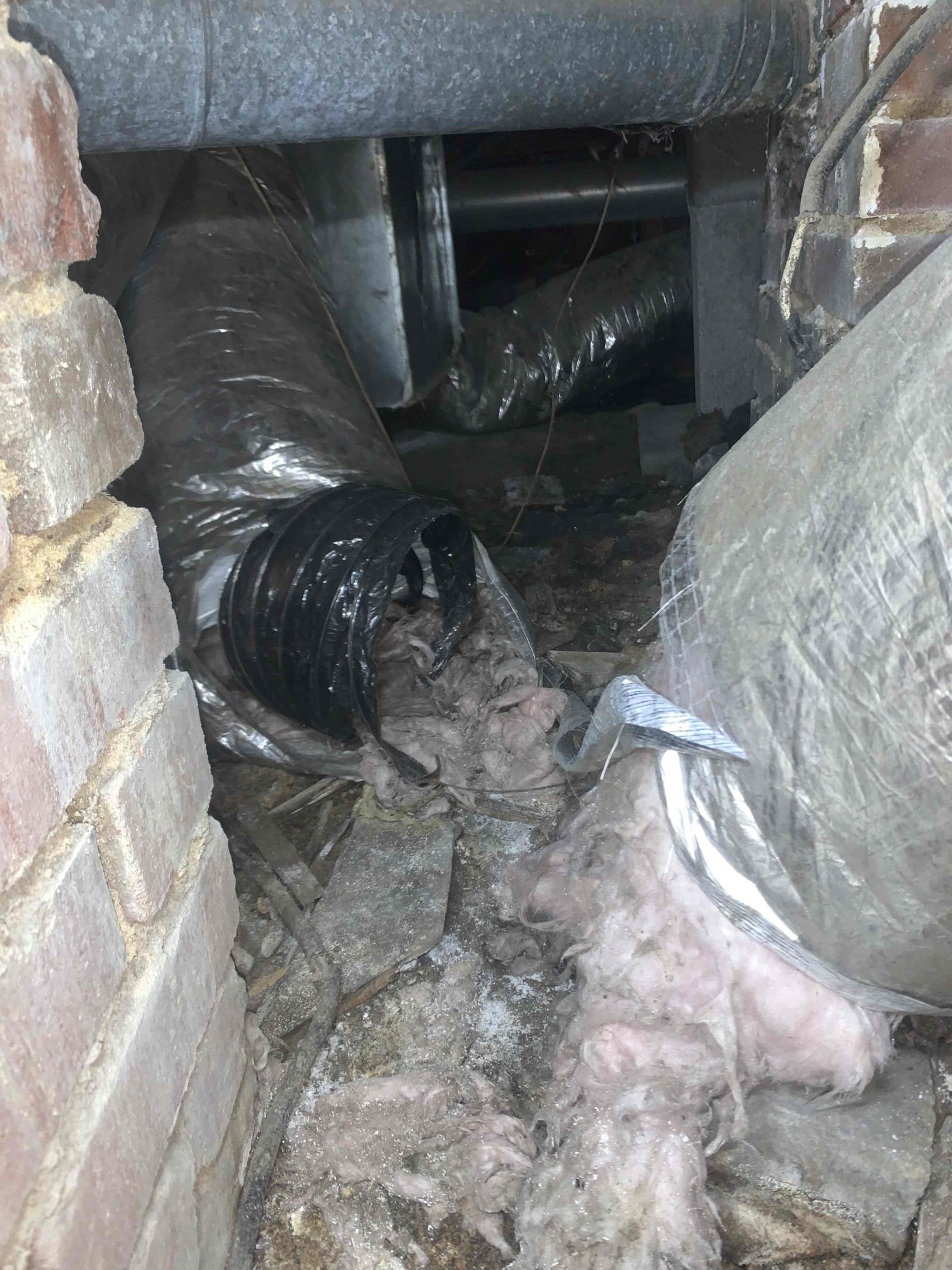 Arrived on site for duct replacement estimate. Began inspection at the crawl space. I initially noticed a large amount of water on the rear right side of house near some water pipe, however I did notice see any active dripping. When I brought his up to the homeowner he stated he knew about the issue and it was not a water leak. I took photos of many sagging and restricted ducts and 3 completely severed ducts. It was found that there are no saddles hanging the duct and there are many kinks and messy duct runs. I also noticed that the flue pipe has a run outside from the unit, however there is a t that is not properly sealed and is letting exhaust gasses out under the house. Discussed with homeowners the immediate safety concern with the flue pipe, the severed ducts, and improperly hung ducts. Homeowner informed us that it did not seem like they were receiving air in their front rooms. Proceeding to the attic I found 2 completely crushed ducts and 1 kink only allowing at best 50 percent 