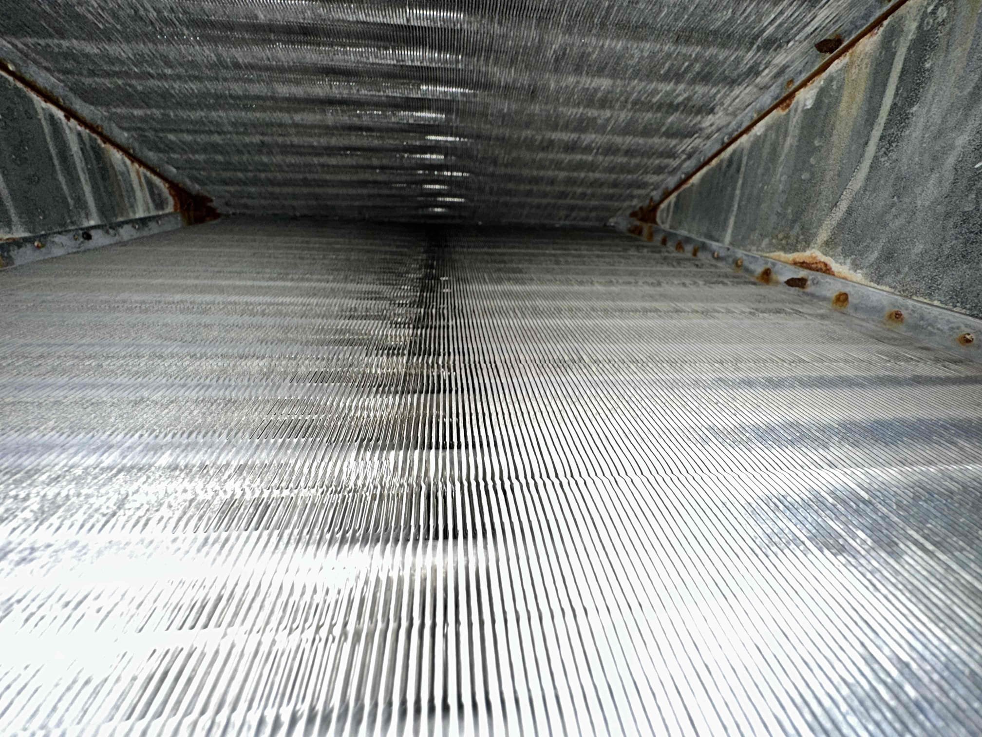 Customer stated that the unit cools fine but drips a little on the bottom part of the coil on the supply side. When I opened the coil, it looks like the blower is throwing water because of static pressure. This is a 4 ton gas system with a 16” return on it. The system needs an additional 14” return added to allow proper airflow for the system. I could not get a clear view of the primary drain pan, but I seen some questionable spot with pictures. With limited access to the evaporator coil, the logical repair is to replace the evaporator coil under warranty because attempting to replace the primary pan only will be extremely labor intensive. I generated an option to add a 14” return to the master bedroom, replace the evaporator coil, and maintenance program on both systems. 
Both systems are from 2019.