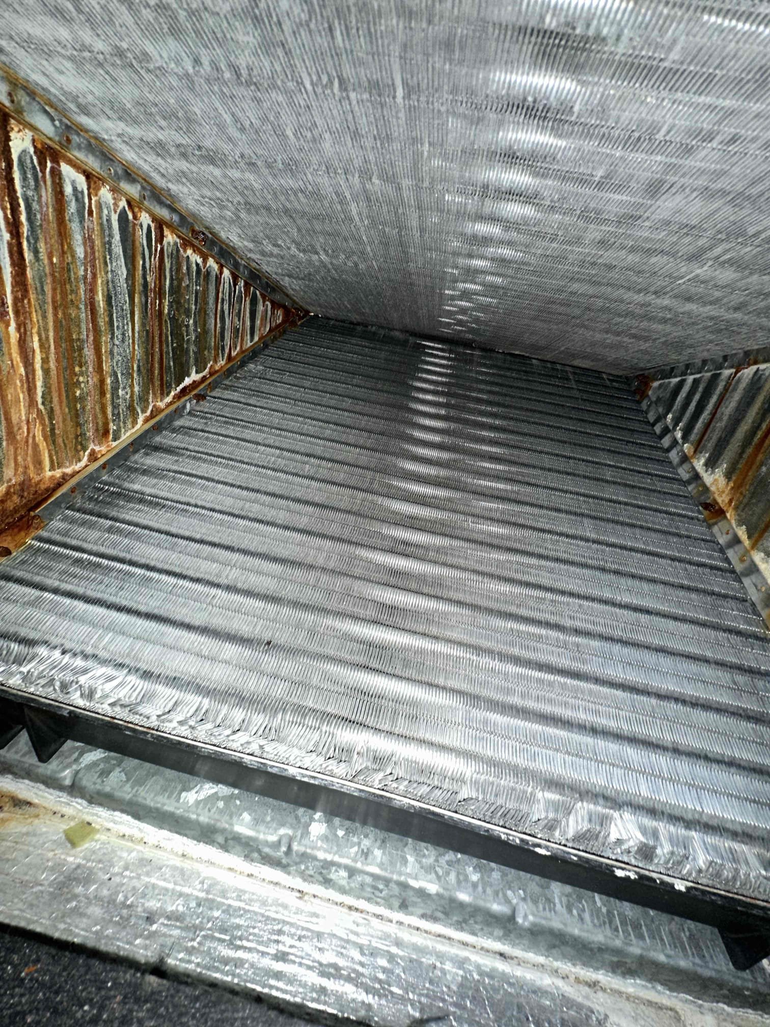 Customer stated that the unit cools fine but drips a little on the bottom part of the coil on the supply side. When I opened the coil, it looks like the blower is throwing water because of static pressure. This is a 4 ton gas system with a 16” return on it. The system needs an additional 14” return added to allow proper airflow for the system. I could not get a clear view of the primary drain pan, but I seen some questionable spot with pictures. With limited access to the evaporator coil, the logical repair is to replace the evaporator coil under warranty because attempting to replace the primary pan only will be extremely labor intensive. I generated an option to add a 14” return to the master bedroom, replace the evaporator coil, and maintenance program on both systems. 
Both systems are from 2019.