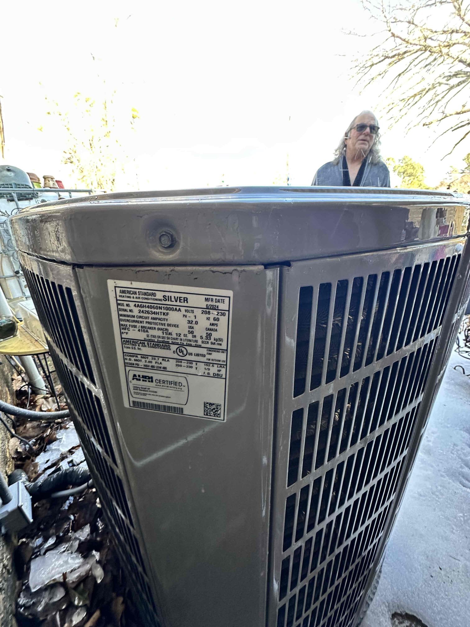 Upon arrival, I found the unit set to emergency heat. I tested the emergency heat and discovered a loss of power to one of the circuits. I went to the main panel and found the breaker off. I turned it on and the electric heat went back to performing at full capacity. I swapped it to heat pump heating and verified that it worked. With the amount of water dripping on the outdoor unit, I did not open the panel to prevent water damage to the components. System is heating in both electric and heat pump heating upon departure. 